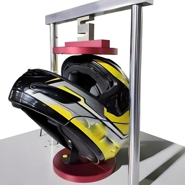 A modular helmet undergoing testing using the Helmet Lateral Force Measurement Assembly Testing Machine at a speed rate of 100N/2 minutes, following the guidelines of the ECE 22.05 standard.