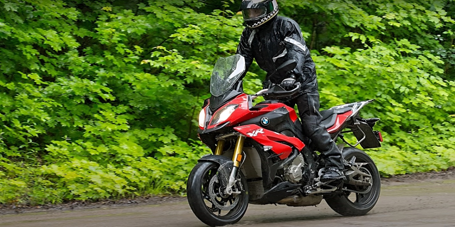 Standing on the pegs of a BMW S 1000 XR while sending it down a paved forest road. The new model is the epitome of sport performance and nimble handling. Motorrad placed the dash so that in this riding position, the bike behaves like an electron — according to Heisenberg's uncertainty principle, you can only know its position or velocity but not both.