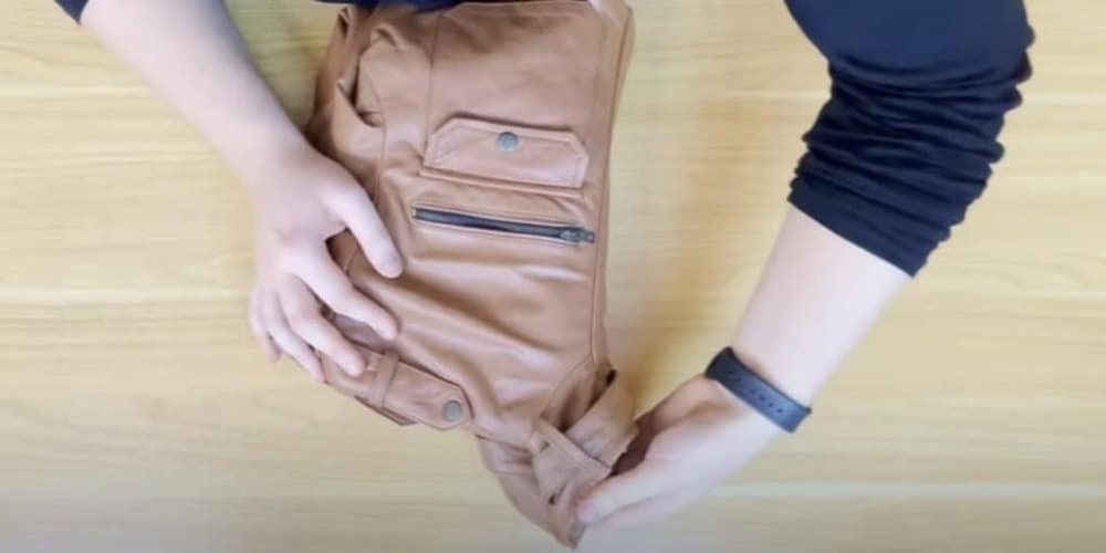Breaking in a brown leather motorcycle jacket: Work the material by folding it into a ball, then straighten it out and hang for storage to eliminate creases and wrinkles.