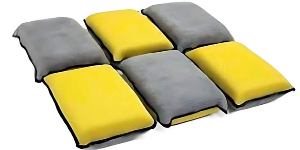Gray and yellow nylon abrasive pads. Break in a leather motorcycle suit by gently rubbing the surface.
