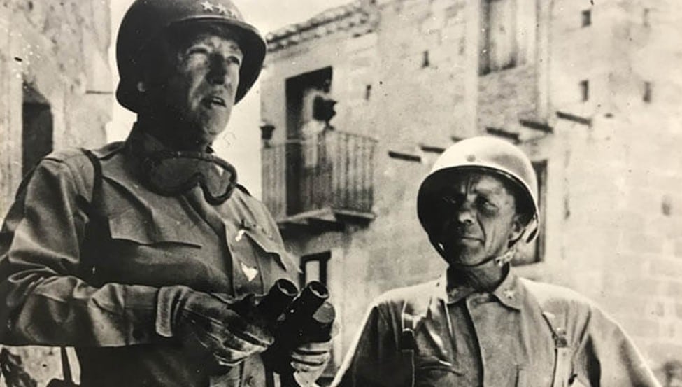 A 1943 photo of Gen. Patton and Gen. Roosevelt wearing the M1, the U.S military’s World War II helmet. Italians wore the M33 (Elmetto Mod. 33) helmet, the Germans wore the Stahlhelm helmet, while the Britons donned the Brodie helmet.