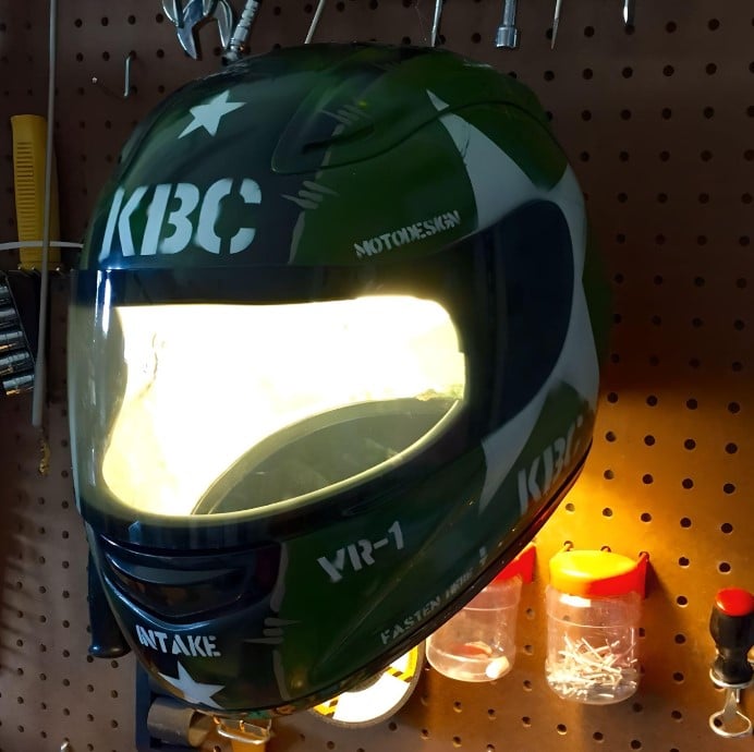 A retired KBC VR1 Silver Combat helmet transformed into a one-of-a-kind lamp, adding a touch of intrigue to a home garage.