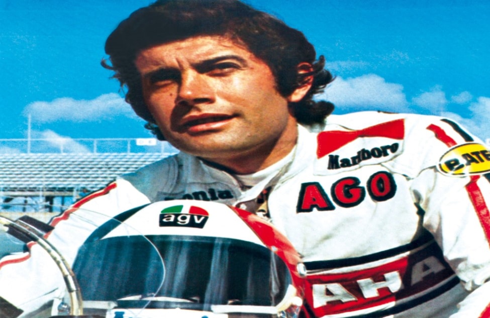 Legendary racer Giacomo Agostini (Ago), a 15-time World Champion (1963-1970), showcases the iconic AGV X3000 helmet that accompanied him throughout his illustrious career.
