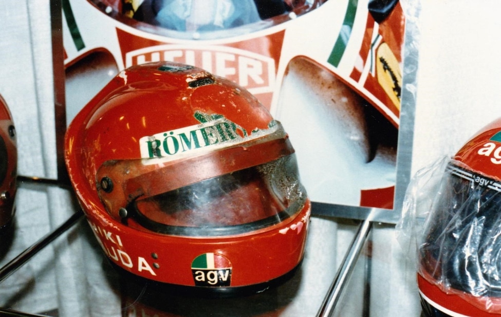 Another image of Niki Lauda's crash helmet, featuring the AGV logo prominently displayed on the chin and his name on the left side.