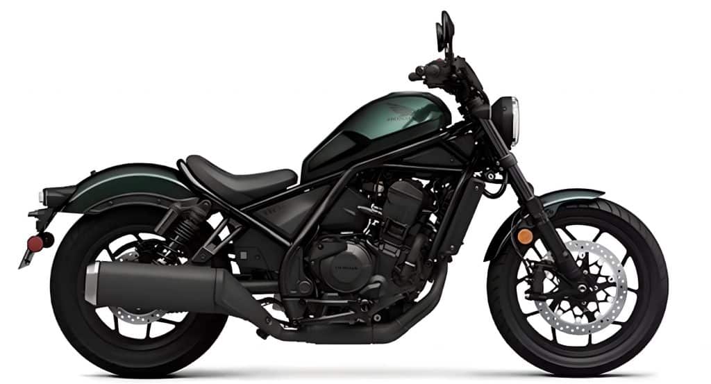 The 2023 Honda Rebel 1100 looks 100% custom, a good example of what you can do with only pre-made bolt-on parts. Notable features include the custom handlebar, LED headlight, custom bracket, resprayed gas tank, and blackened engine cover.