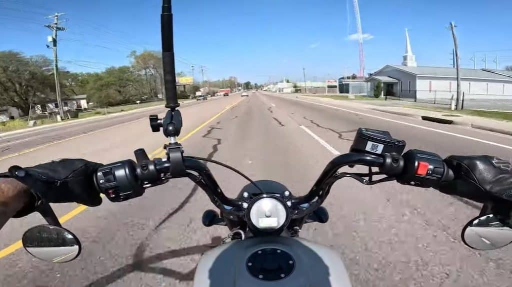 Riding a 2023 Indian Scout Bobber Twenty through the Wall Street Industrial Park in Garland, TX. The simple minimalist instrumentation with an RPM gauge (of course it’s digital), ABS, neutral indicator, low fuel light, check engine light, hazards and turn signal indicator, all in accordance with Texas street motorcycle regulations. But unlike the 2023 Ducati XDaviel Dark, the side mirrors are inverted. A small 3.3-gallon tank is enough to zip round town, delivering an impressive 40 miles to the gallon.