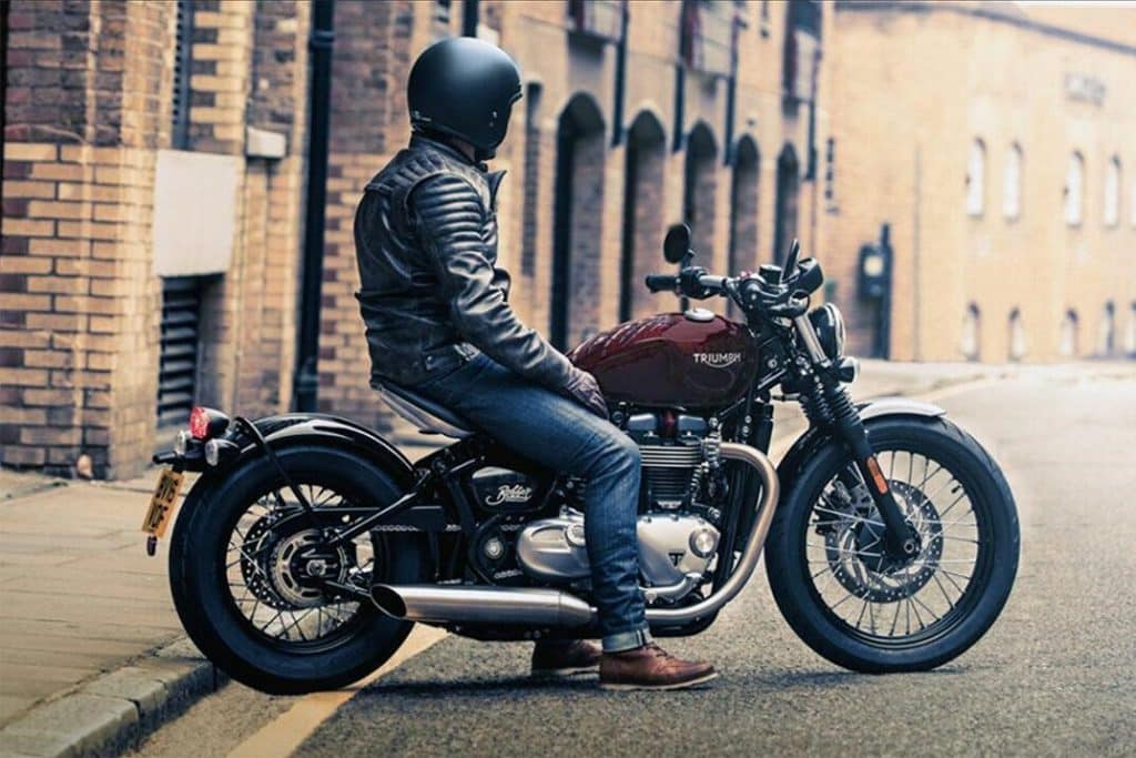 A rider takes in the city views on the 2023 Triumph Bonneville Bobber. Building a motorcycle, custom or not, and getting to ride down the street can be such a thrilling and rewarding experience.