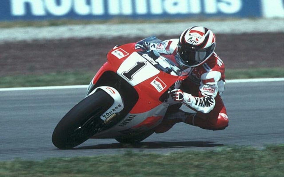 Wayne Rainey leans into a corner as he races to victory, donning an AGV helmet.