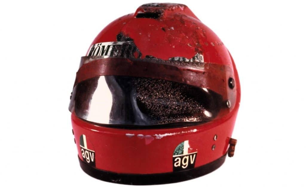 The AGV X1 helmet worn by Niki Lauda during the 1976 Nürburgring crash. Visible are the significant damages, particularly on the face shield, attributed to the fire that left a scorch mark on a portion of his face. For a period of six years (1987 to 1993), I had this actual helmet from the crash displayed in my living room as part of my collection.