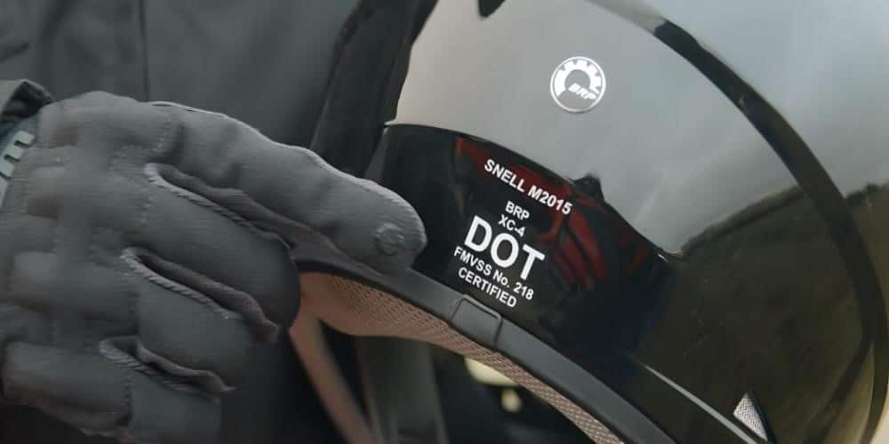 a helmet with safety certifications displayed on the back, including labels and markings indicating compliance with safety standards.