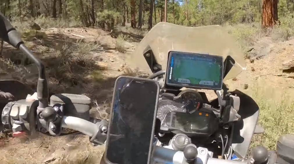 Quick-release phone mount, RAM mount ball adapters for multiple camera mounting locations on the handlebars, and a navigation system mounted above the main instrument cluster.