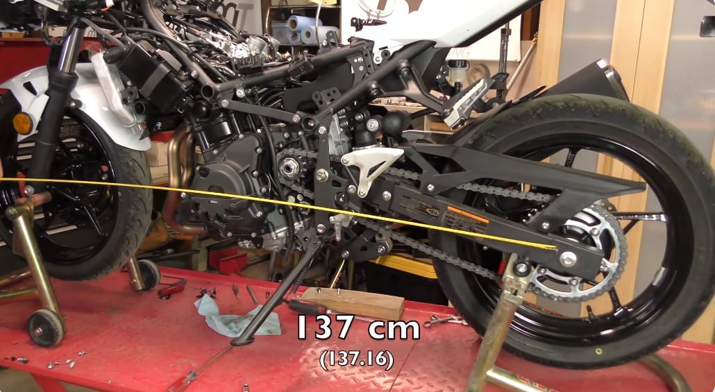 Removing the fairings for a regular maintenance routine on the Kawasaki Z400 entry-level street bike gives us an opportunity to measure straight between the two wheel centers for the wheelbase, which is approximately 137.16 centimeters (53.9 inches) in this case.