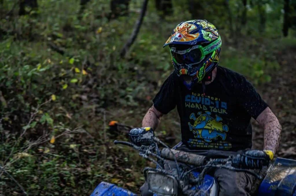 The AGV AX-8 Rossi 5-Continents Evo helmet has endured its fair share of muck, testament to my intense ATV riding escapades. Despite the grime, its vibrant multicolor design maintains visibility.