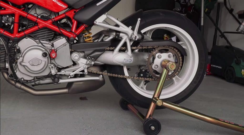 The long lever on the Pit Bull Hybrid One Armed Rear Stand hoists the 178 kg / 392 lbs. 2006 Ducati S2R1000 with a single-sided swingarm. Working on a heavy motorcycle without a paddock stand can be a health hazard and incredibly difficult, especially since they lack a center stand.