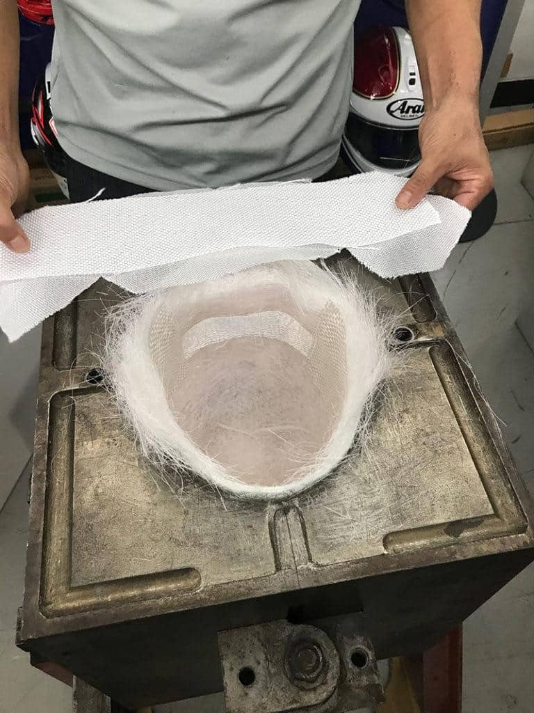 Following the preparation stage, the preforma or "bird's nest" is carefully inserted into the mold, poised for the subsequent layering process.